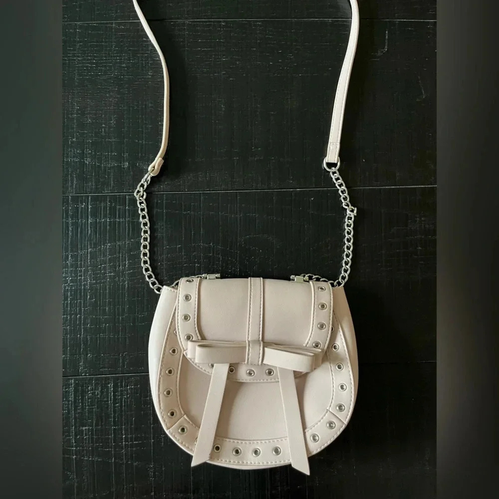 Express Cream Grommet Bow Crossbody Bag